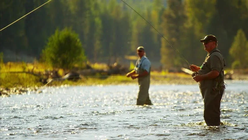 Fly angler casting on Montana mountain river