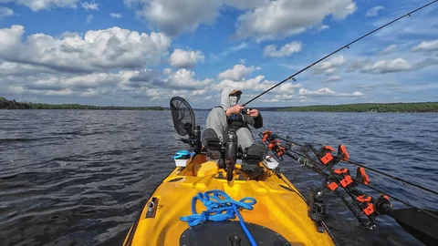 Angler fishing from a kayak at sunrise