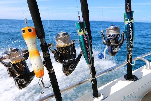 Saltwater fishing rods and reels rigged on a boat